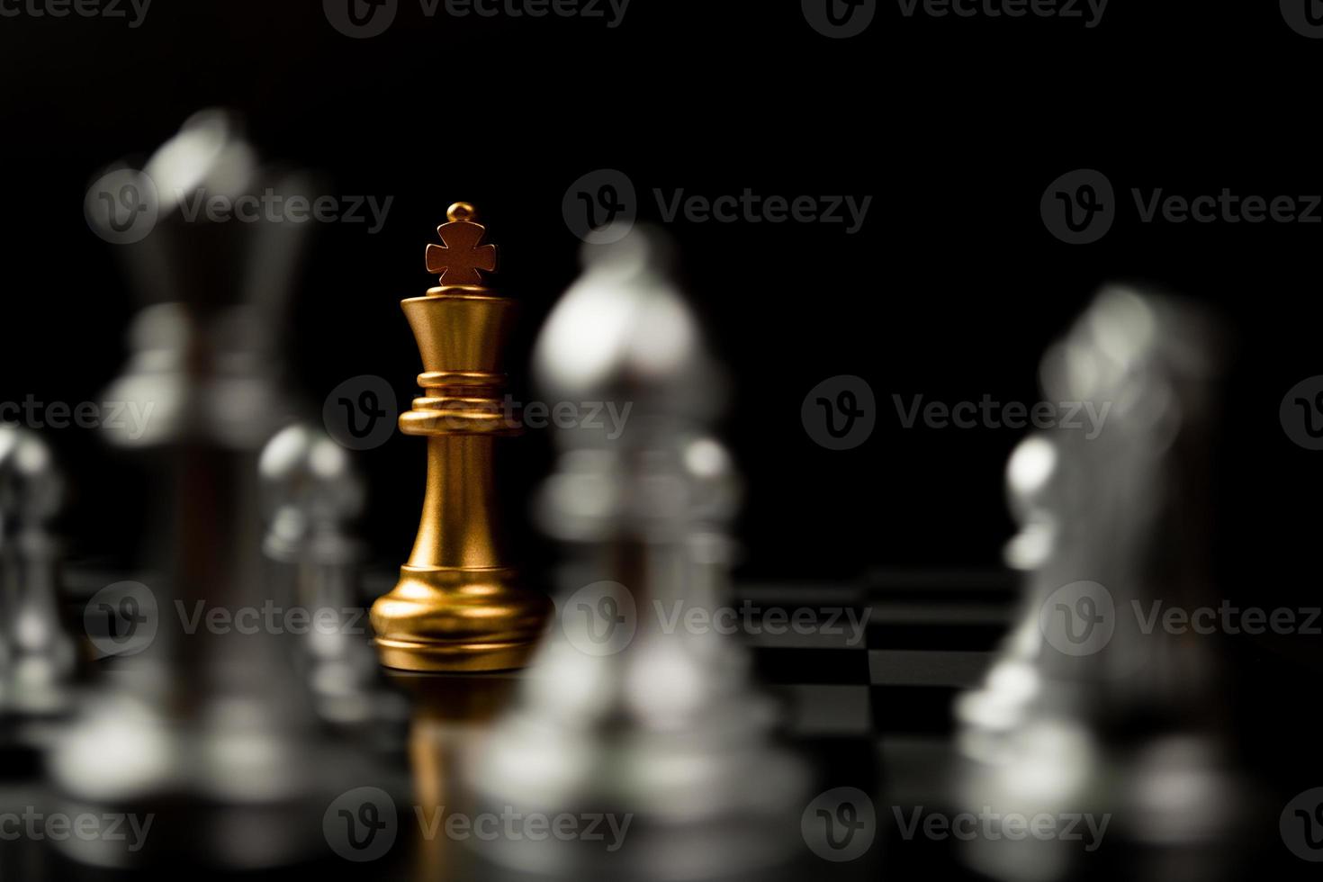 Golden King chess standing in front of other chess, Concept of a leader must have courage and challenge in the competition, leadership and business vision for a win in business games photo