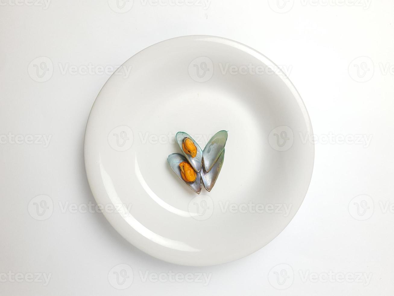 Green Mussel on a plate on a white background, Fresh New Zealand Mussel or Perna Canaliculus on a White Background. isolated green mussels. photo