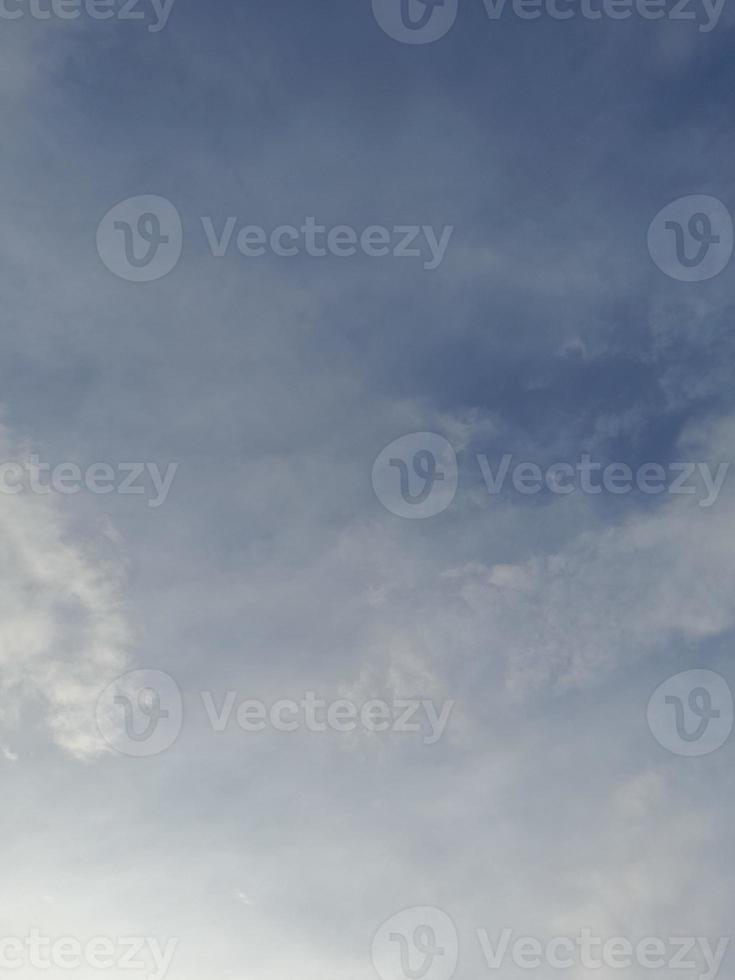 Beautiful white clouds on deep blue sky background. Large bright soft fluffy clouds are cover the entire blue sky. photo