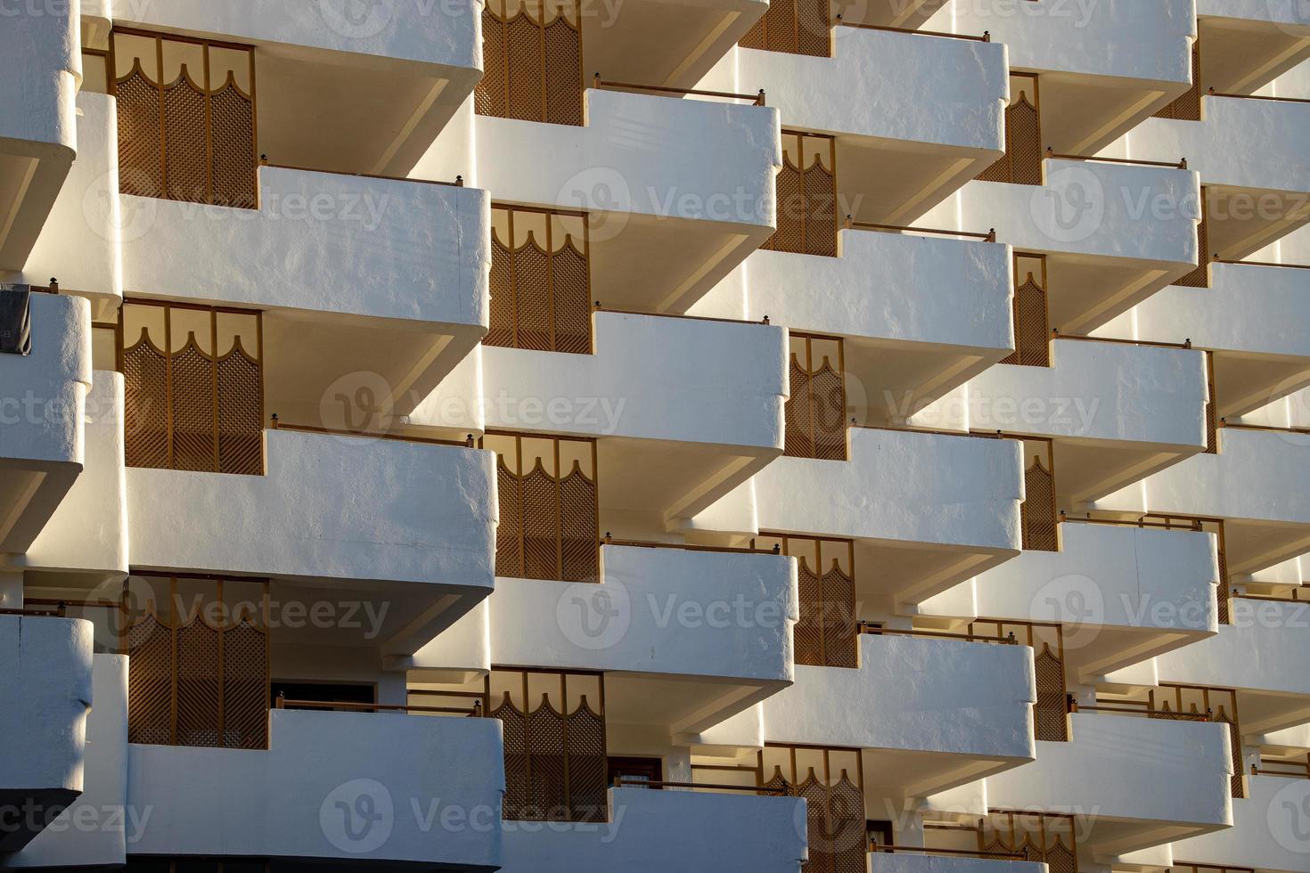 interesting original elements of the balconies in the white building photo