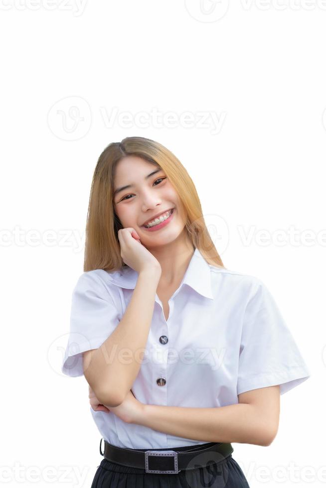 Portrait of an adult Thai student in university student uniform. Asian cute girl standing with her hand holding face confidently isolated on white background. photo