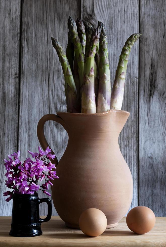 Cervia, Ravenna province, Italy April 12, 2023. Still life and composition with terracotta pot, asparagus and eggs in natural light. photo