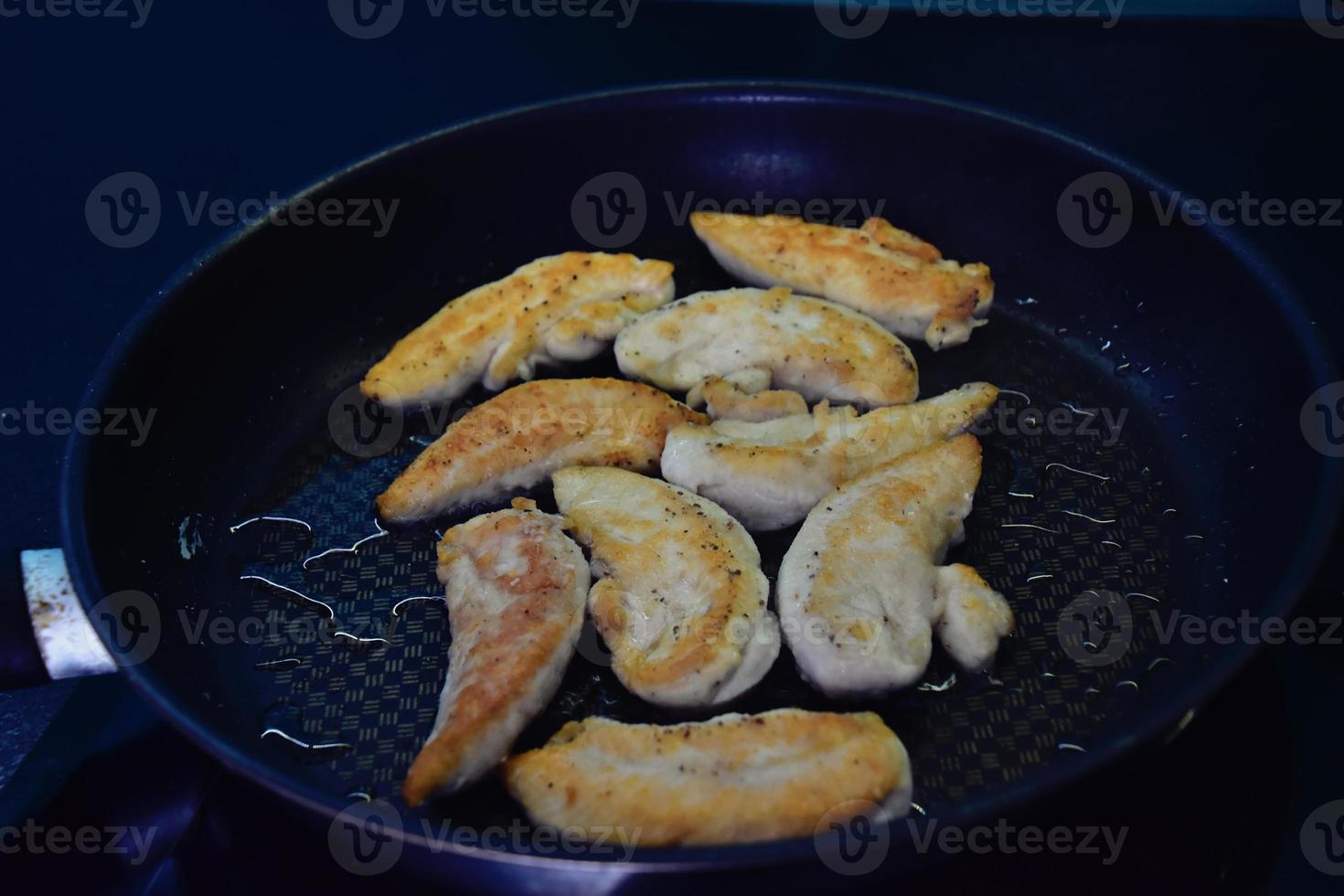 fragrant fresh dumplings fried on a hot pan in kitchen photo