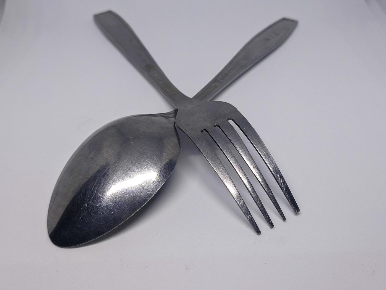 A close up of spoon and fork with white background photo