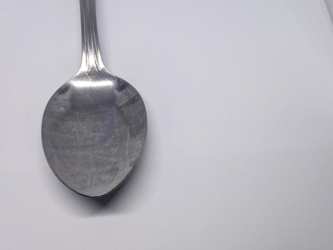 A close up of spoon with white background photo