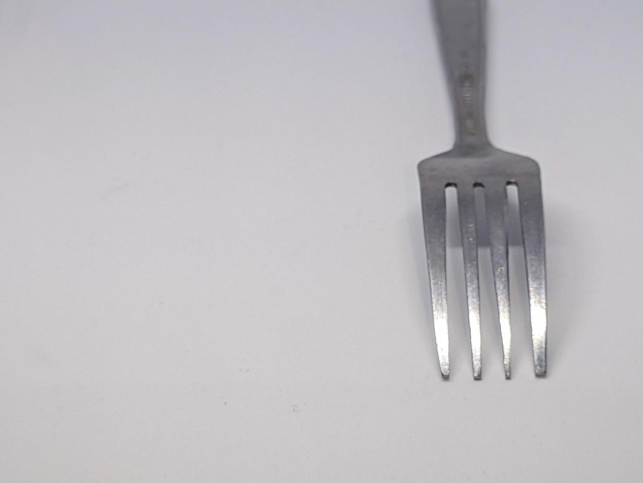 A close up of fork with white background photo