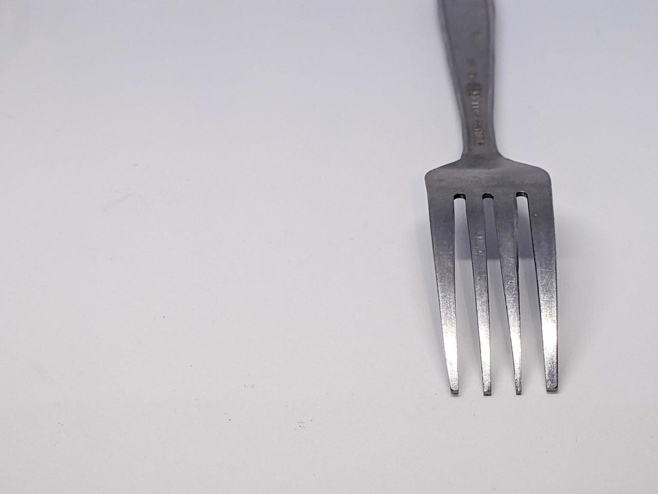 A close up of fork with white background photo