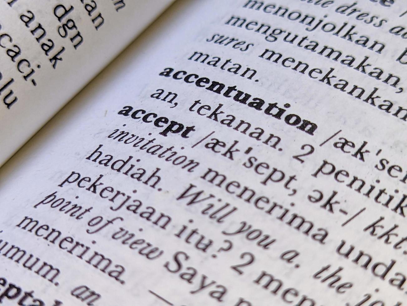 Surabaya, indonesia - april, 2023 - a close up of the word accept in the English to Indonesian dictionary. For language background or wallpaper photo