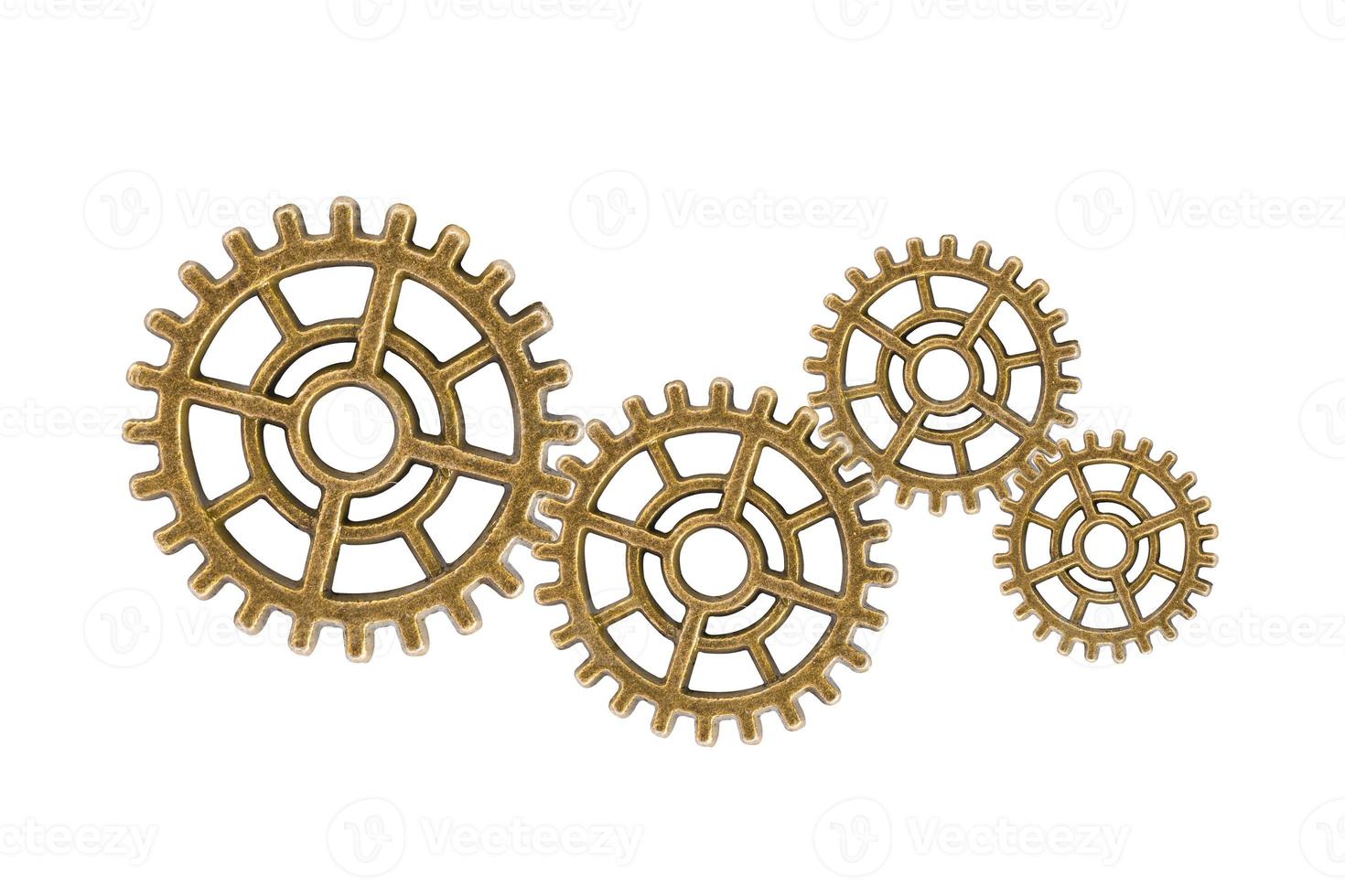 Gear and cogs wheels isolated on a white background, clock mechanism, brass metal engine industrial. photo