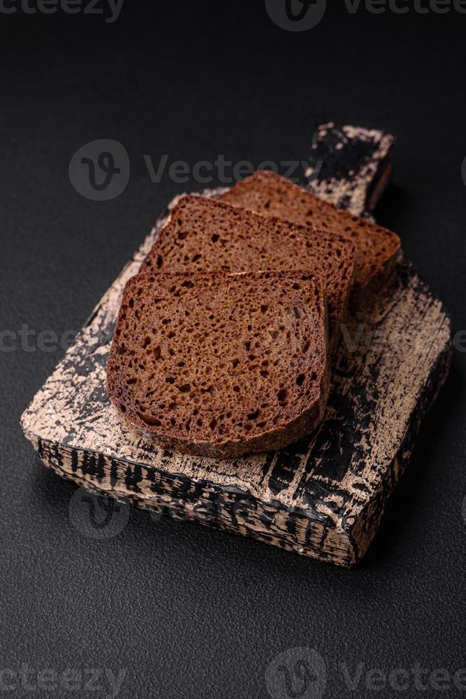 Loaf of fresh crispy brown bread with grains and seeds photo