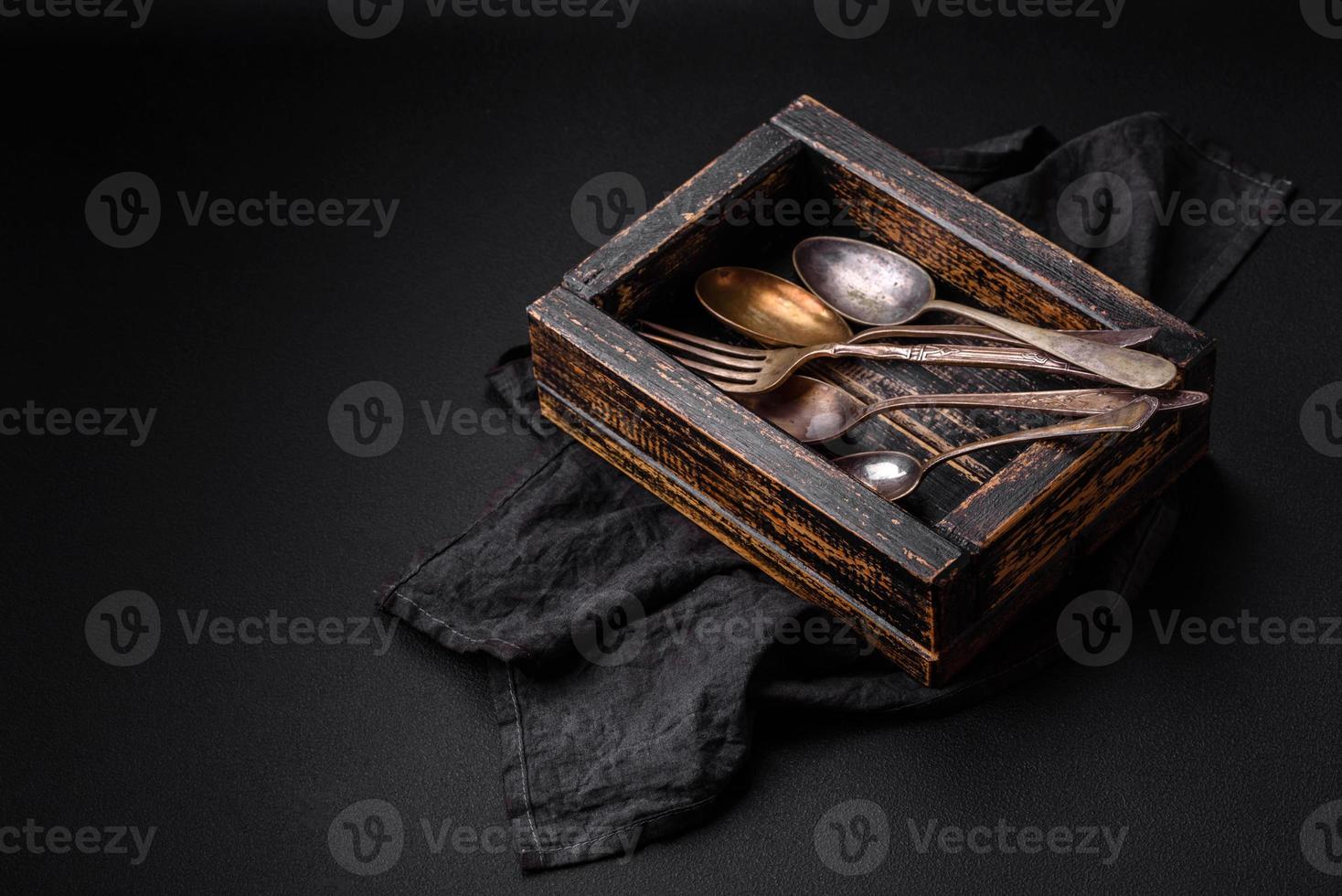 Vintage rectangular shabby wooden box with spoons and forks photo