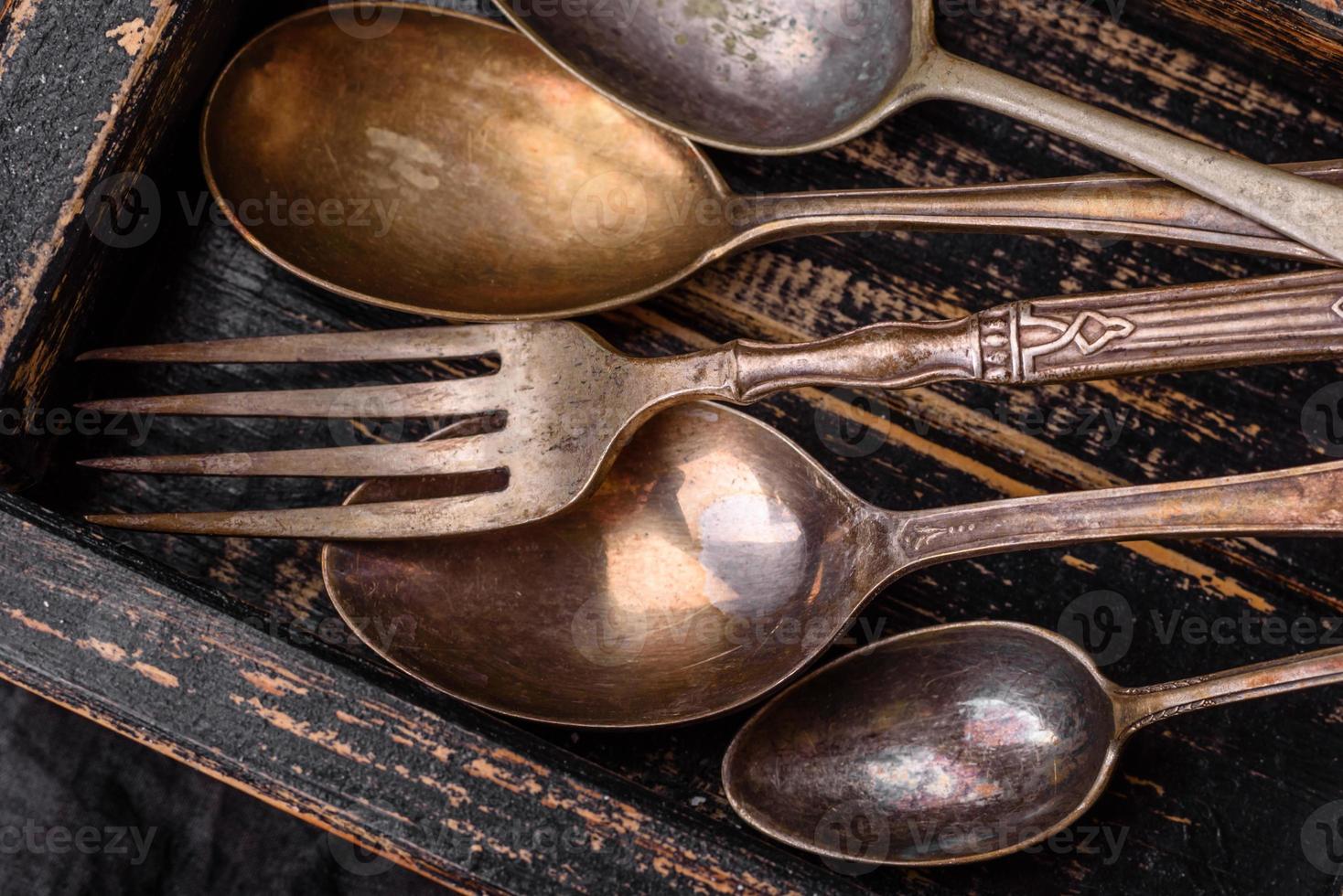 Vintage rectangular shabby wooden box with spoons and forks photo