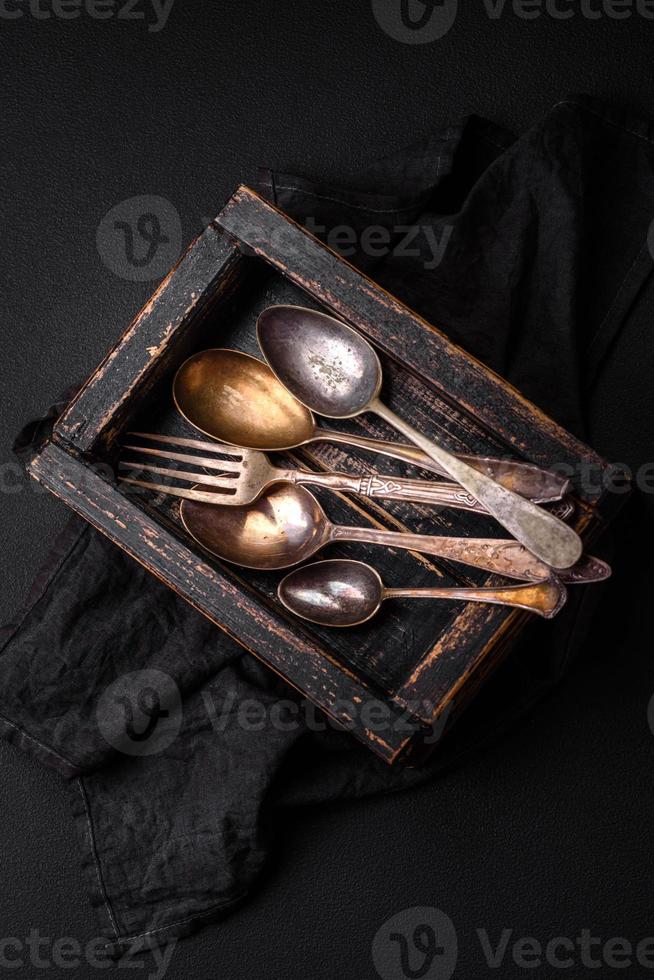 Vintage rectangular shabby wooden box with spoons and forks photo