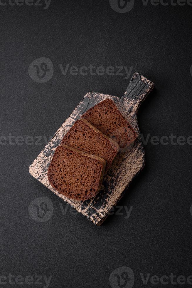 Loaf of fresh crispy brown bread with grains and seeds photo