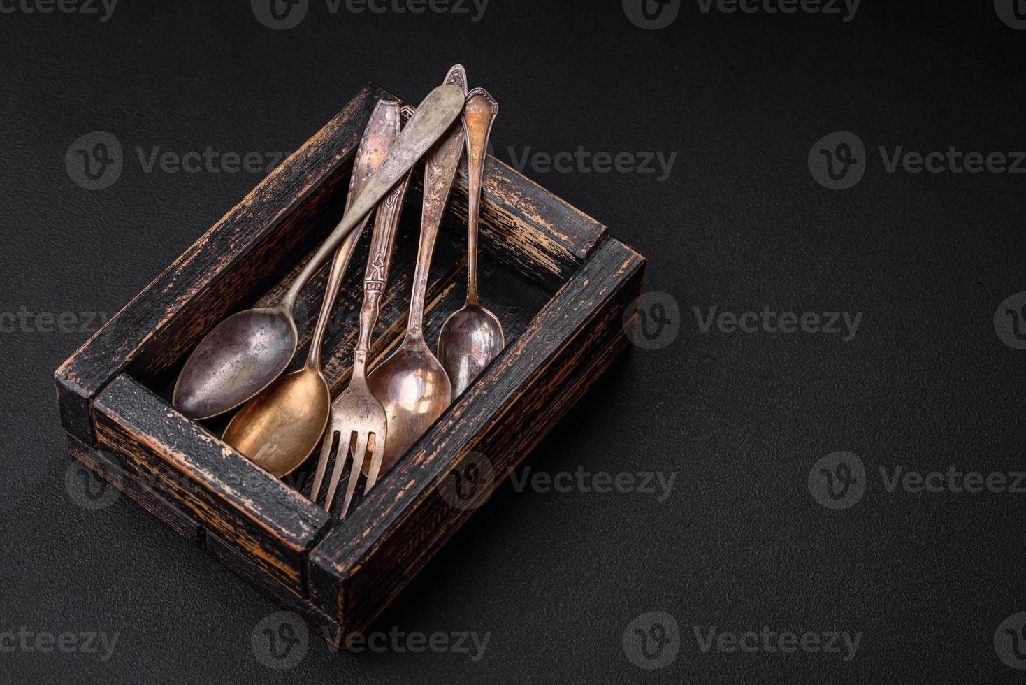 Vintage rectangular shabby wooden box with spoons and forks photo