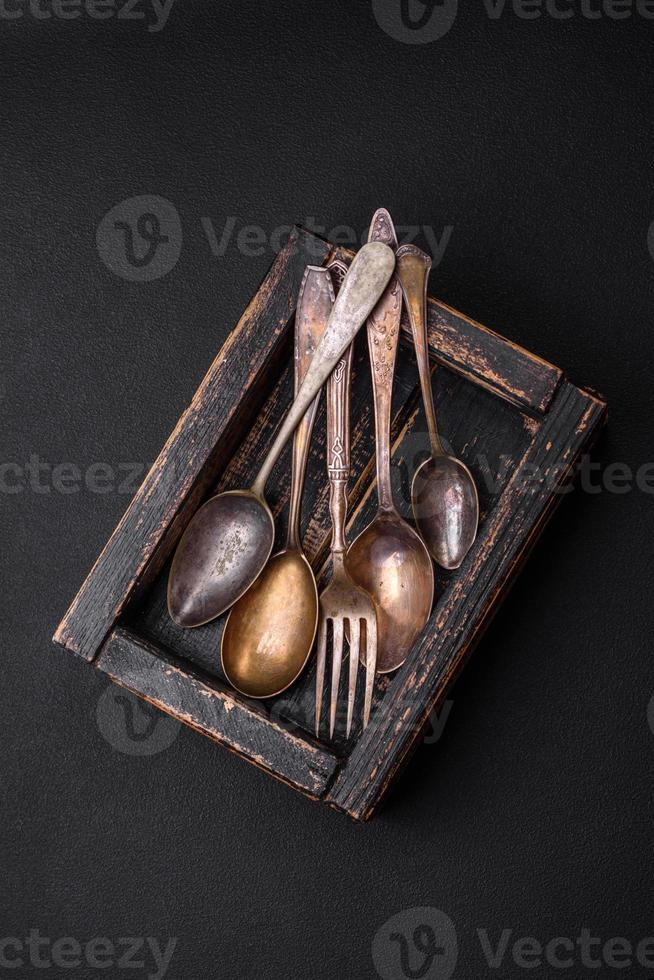 Vintage rectangular shabby wooden box with spoons and forks photo