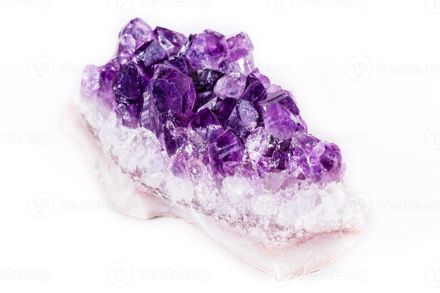 Macro mineral stone purple amethyst in crystals on a white background photo