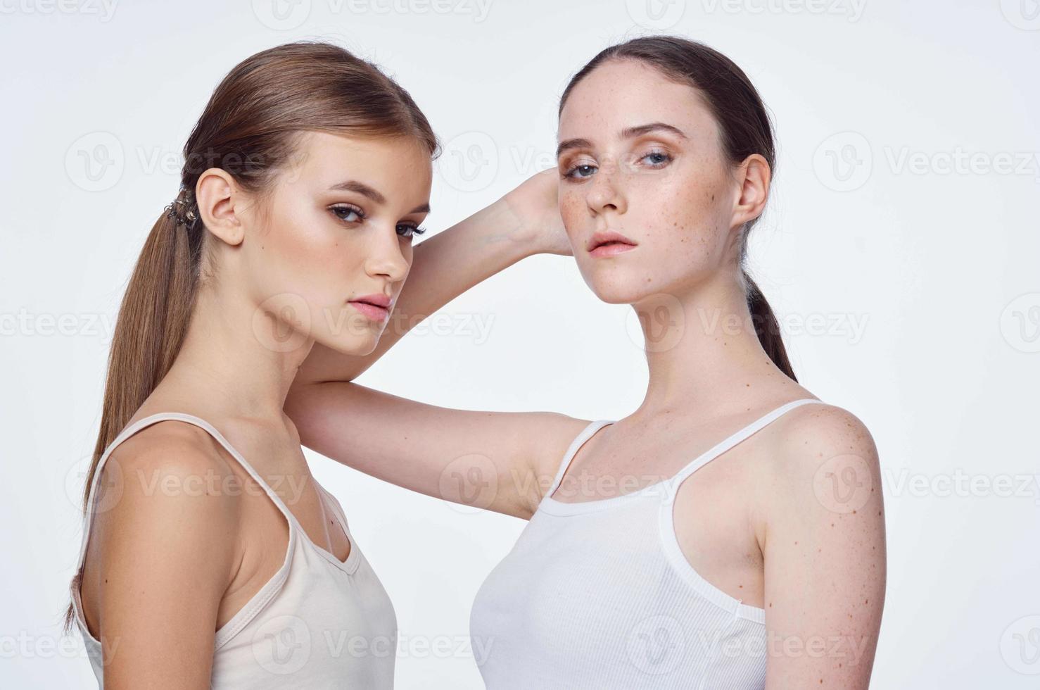 Brunette women on white tank tops photo