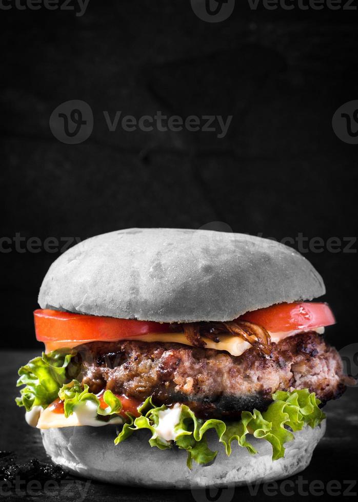 Burger close-up on dark background photo
