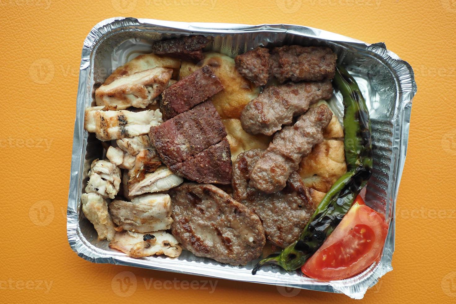 Donor kebab in a plastic packet on table photo