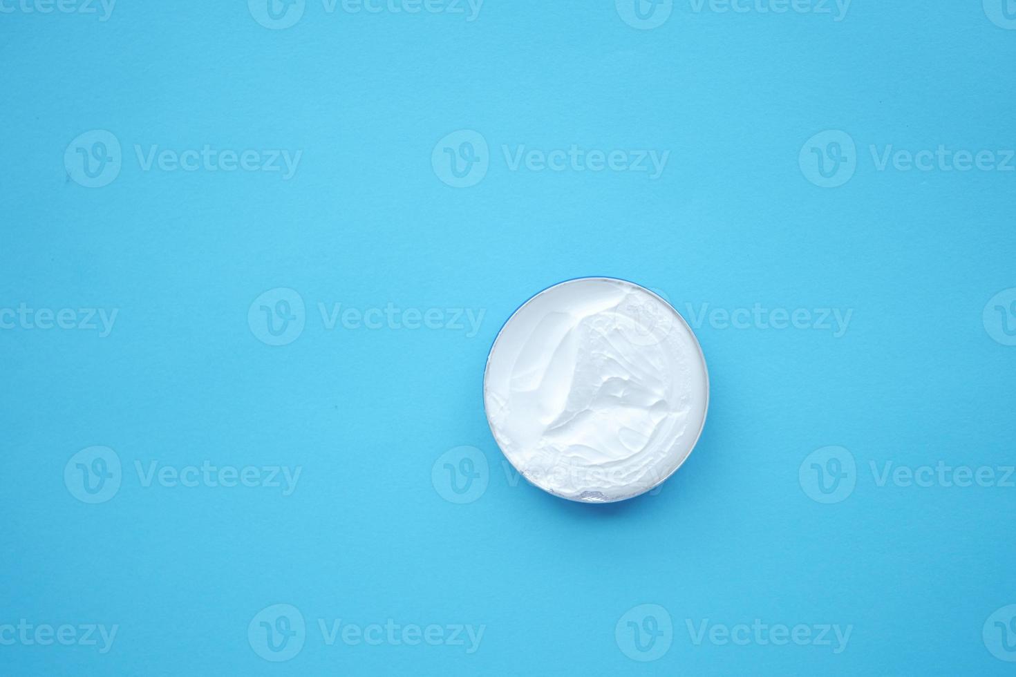 top view of beauty cream on blue background photo