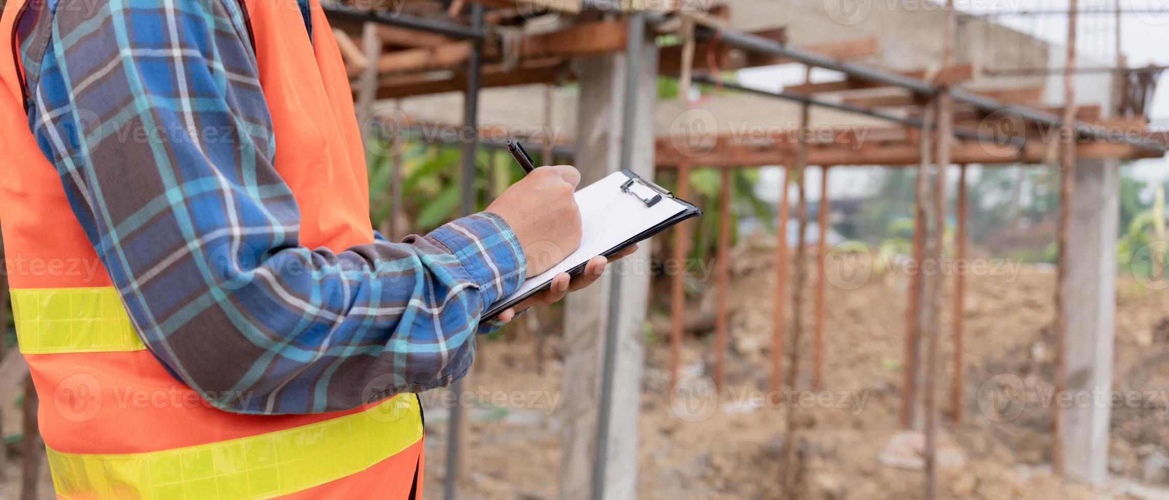 inspector or engineer is inspecting construction and quality assurance new house using a checklist. Engineers or architects or contactor work to build the house before handing it over to the homeowner photo