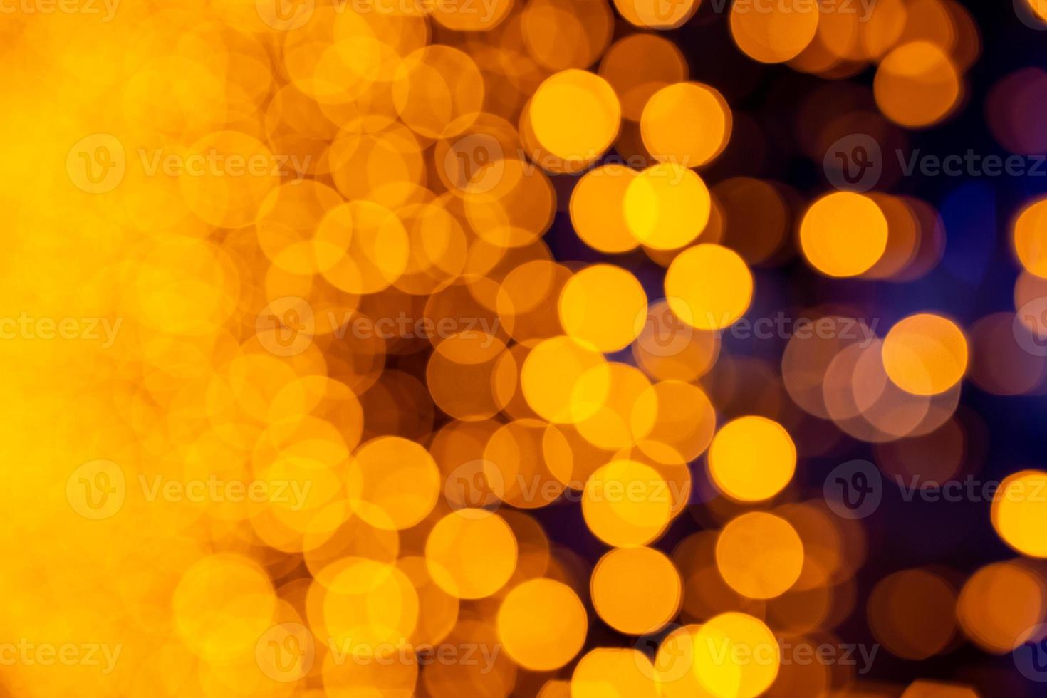 Bokeh de fondo circular abstracto de luz navideña. bokeh de guirnaldas. fondo para salvapantallas. luces desenfocadas. Bokeh borroso con luces de color amarillo. foto