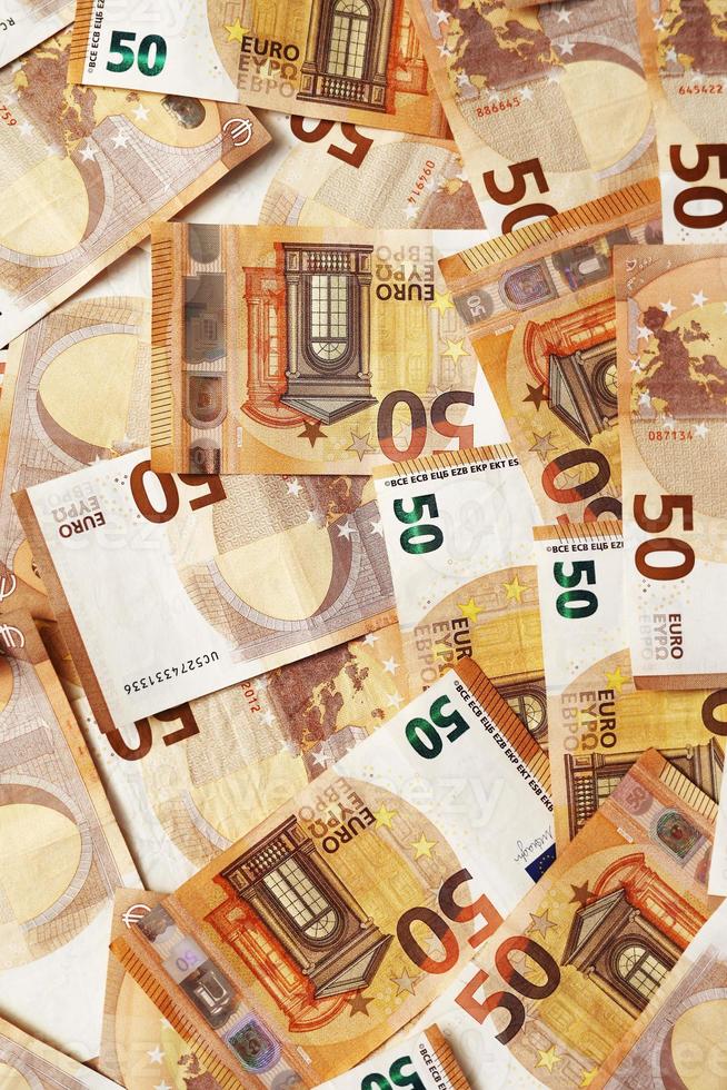background of banknotes 50 euros beautifully laid out. Euro money. European Union banking, financial savings. concept of economy. banks, money, wealth, finance and business success. photo