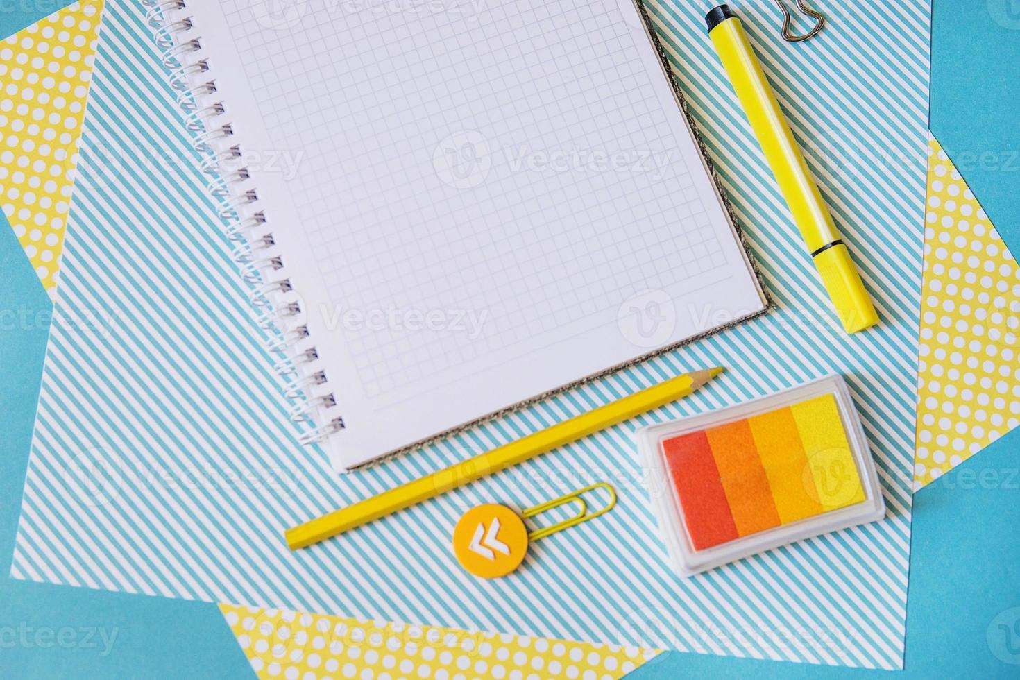 School supplies. Yellow and blue colors. Empty notebook. Flat lay composition. Space for text. photo