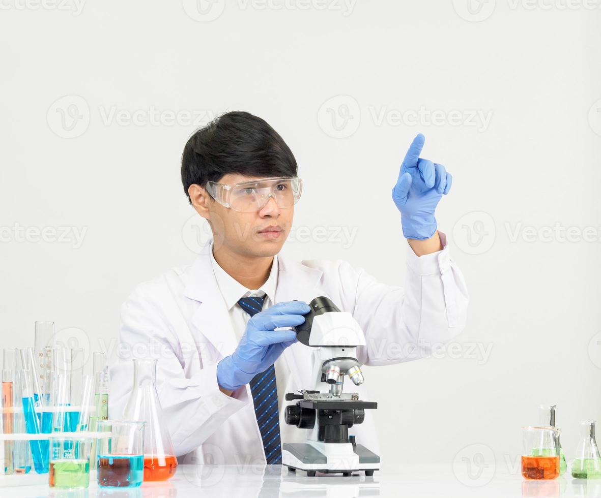 Asian man student scientist in reagent mixing laboratory In a science research laboratory with test tubes of various sizes. on the floor in  laboratory chemistry lab white background. photo