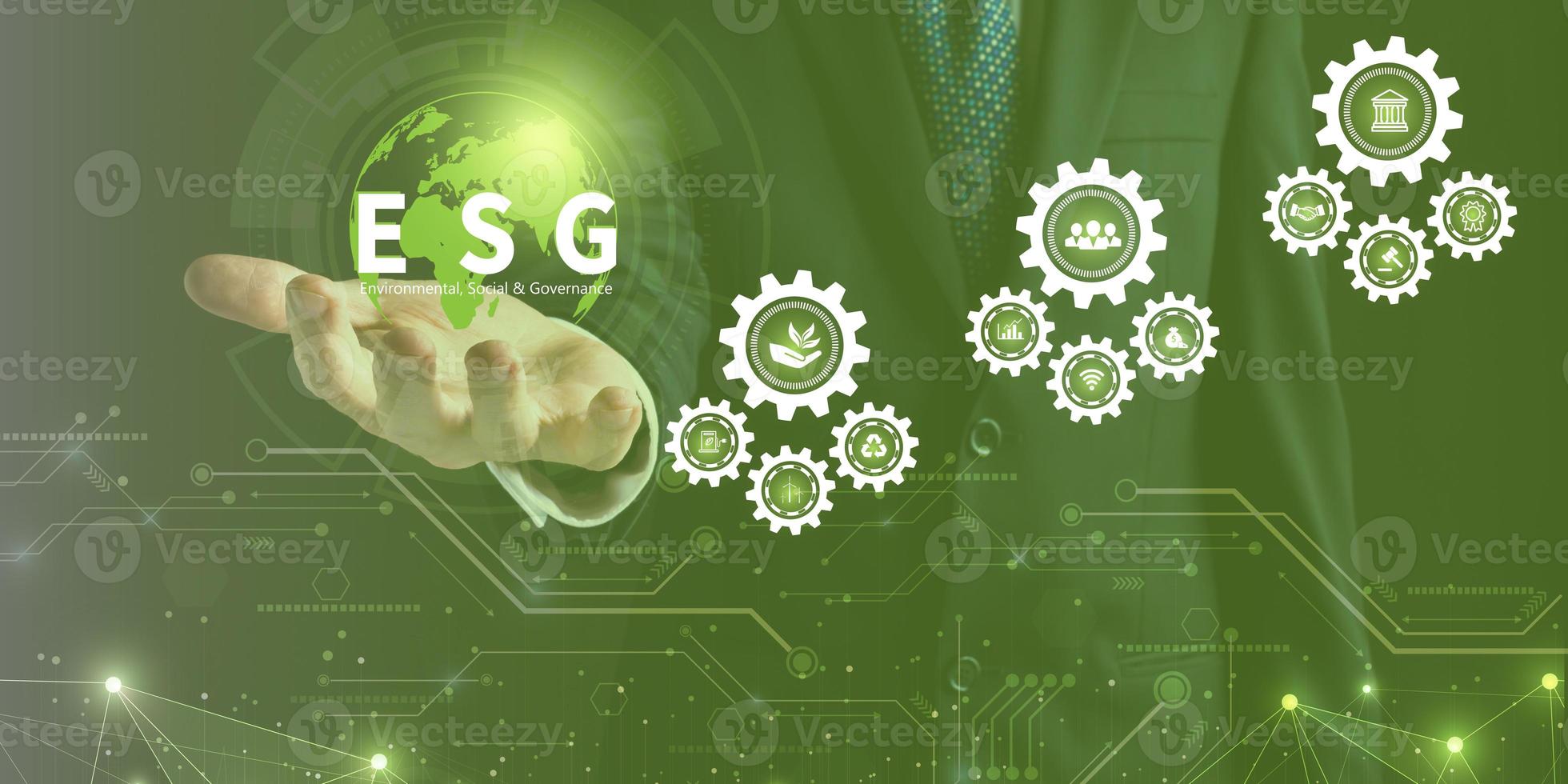 Businessman touching ESG icon on virtual screen for environmental, social, and governance in sustainable and ethical business on a technology green background. photo