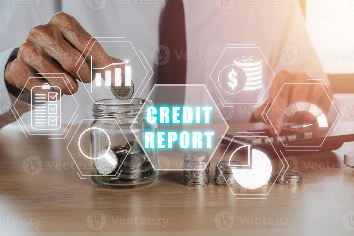 Credit report concept, Businessman putting coin into glass jar with credit report icon on virtual screen photo