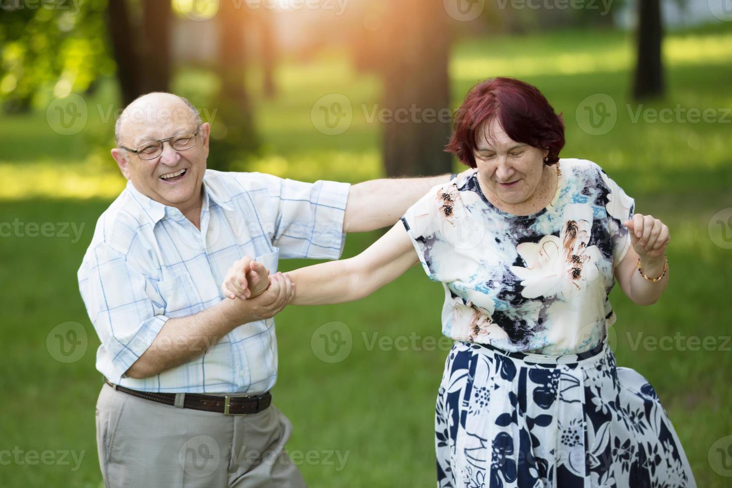 Happy elderly couple. Handsome man and woman senior citizens. Husband and wife of old age in the park. photo