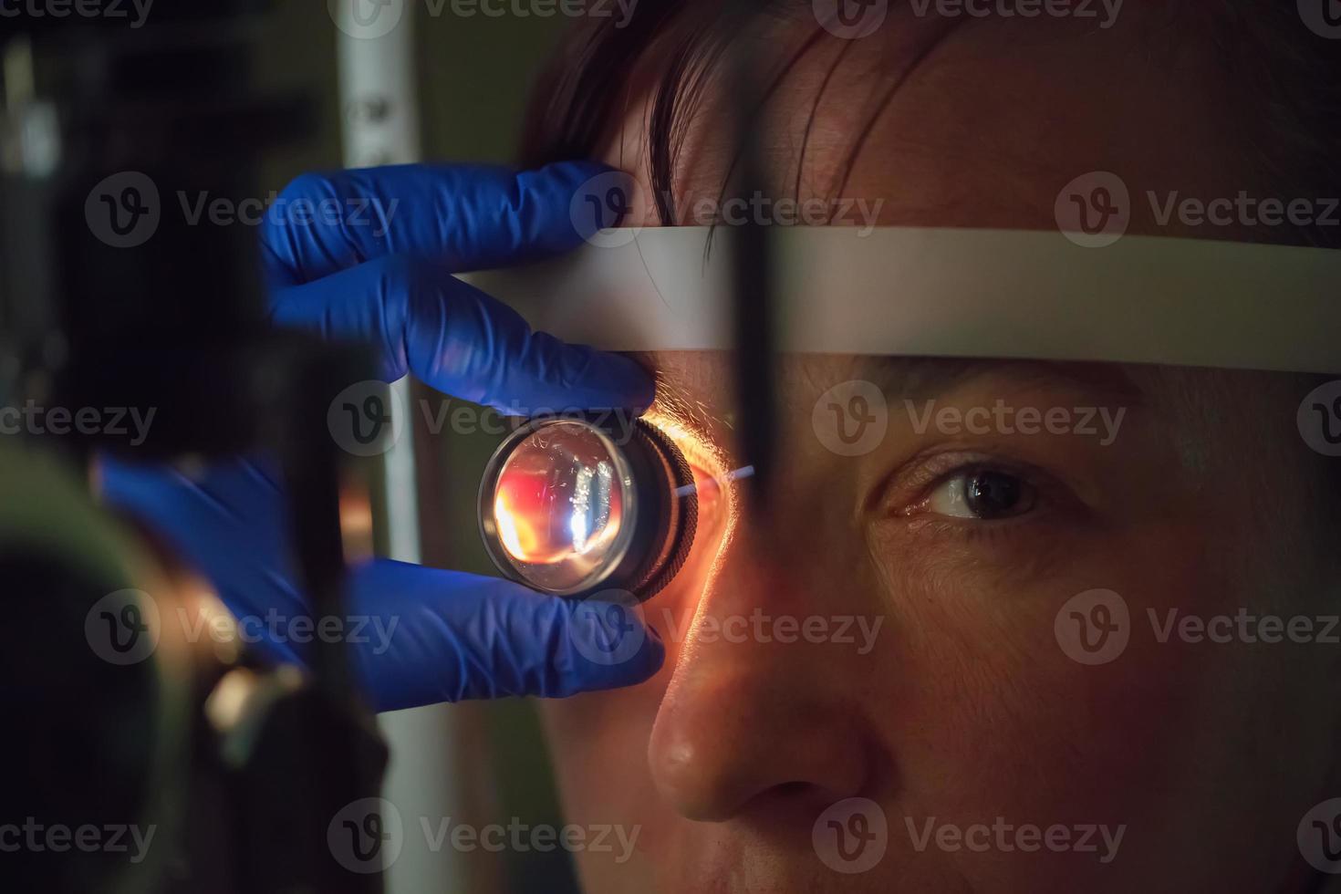 An ophthalmologist checks the fundus of the patient. photo