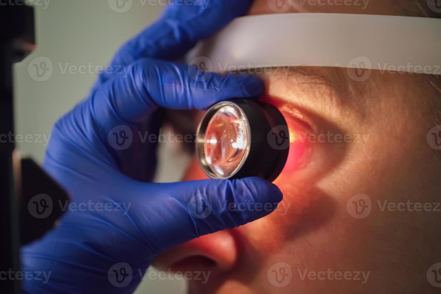 An ophthalmologist checks the fundus of the patient. photo