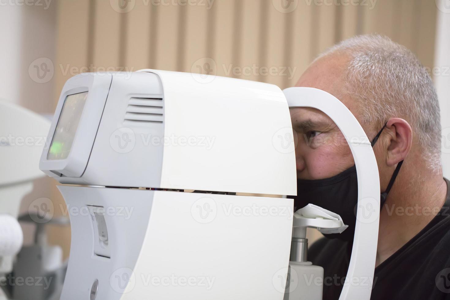 An ophthalmologist checks the fundus of the patient. photo