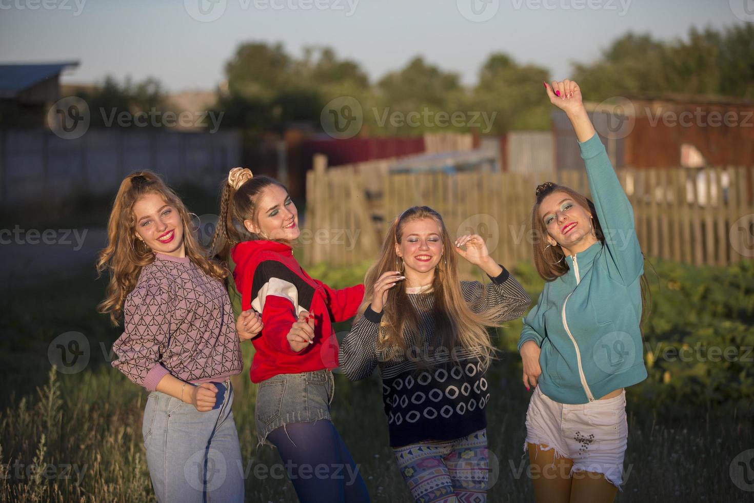 Girls in the style of the nineties. Country girls posing for the camera. photo