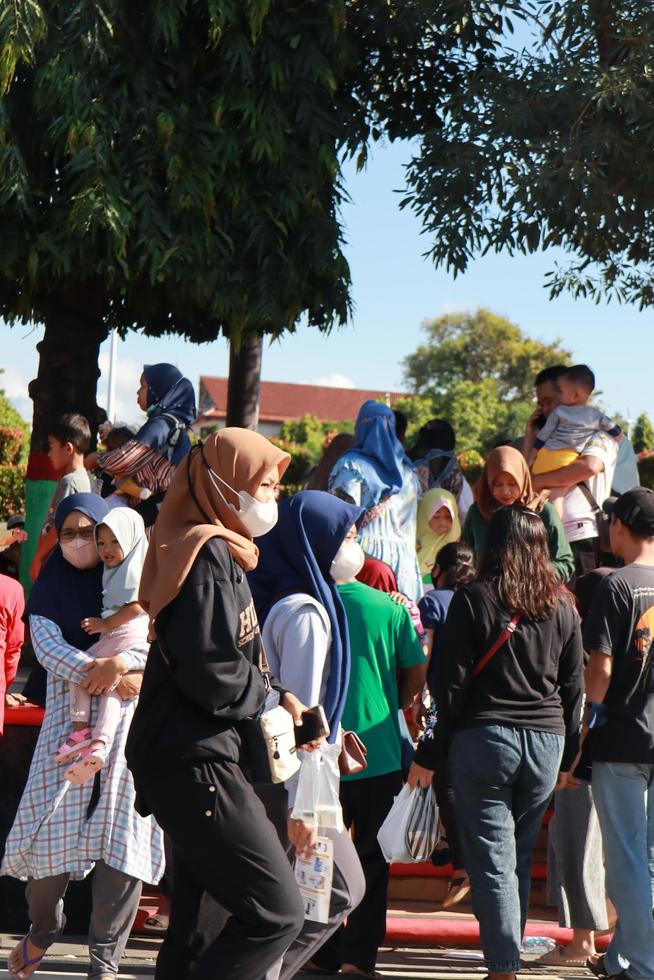 Kudus, January 2023. A snapshot of the crowds of car free day visitors crossing the zebra crossing to get to alun alun simpang 7 kudus. photo