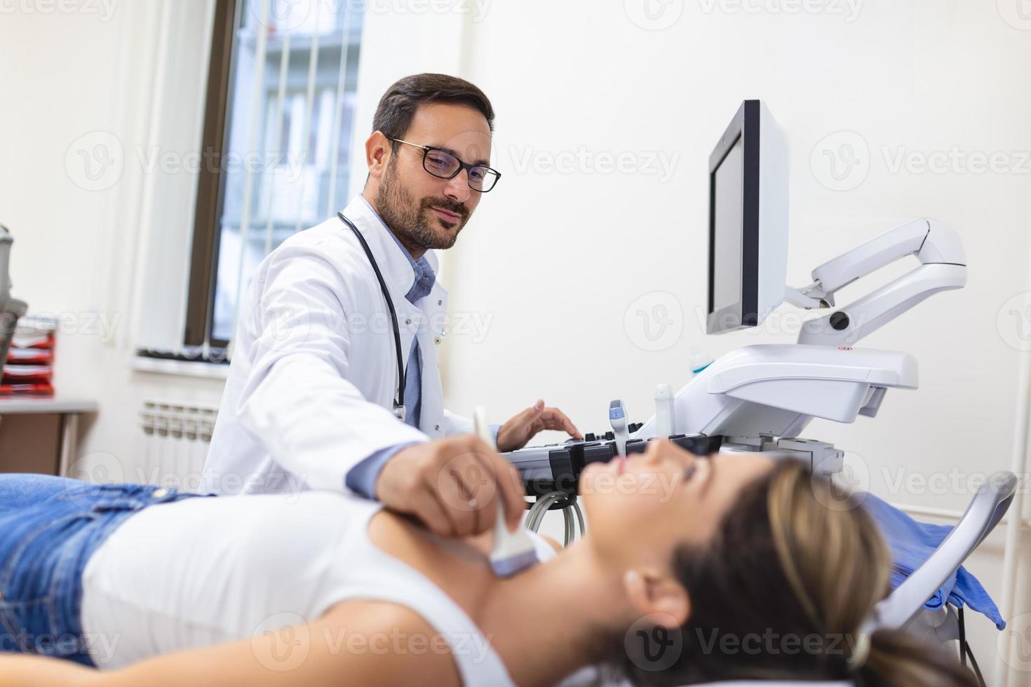 Woman patient receives thyroid diagnostics. Treatment of thyrotoxicosis, and hypothyroidism. Ultrasound diagnostics of the endocrine system and thyroid photo