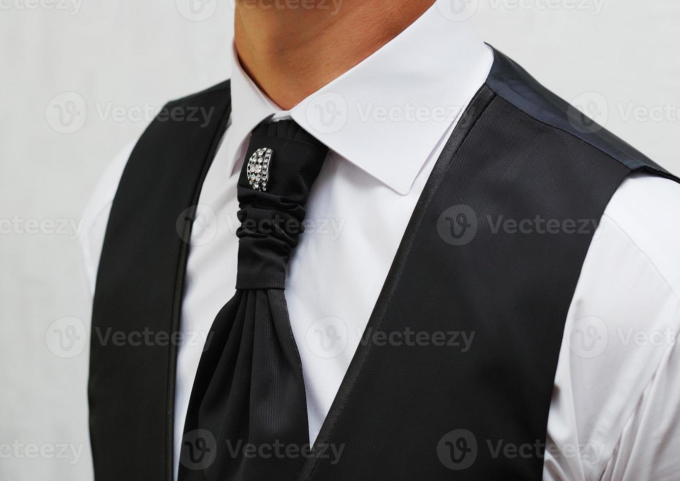 A tie on the groom, a festive suit photo