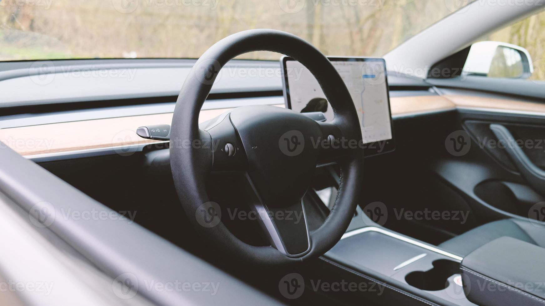 Interior dashboard with a modern interface design and steering wheel. photo