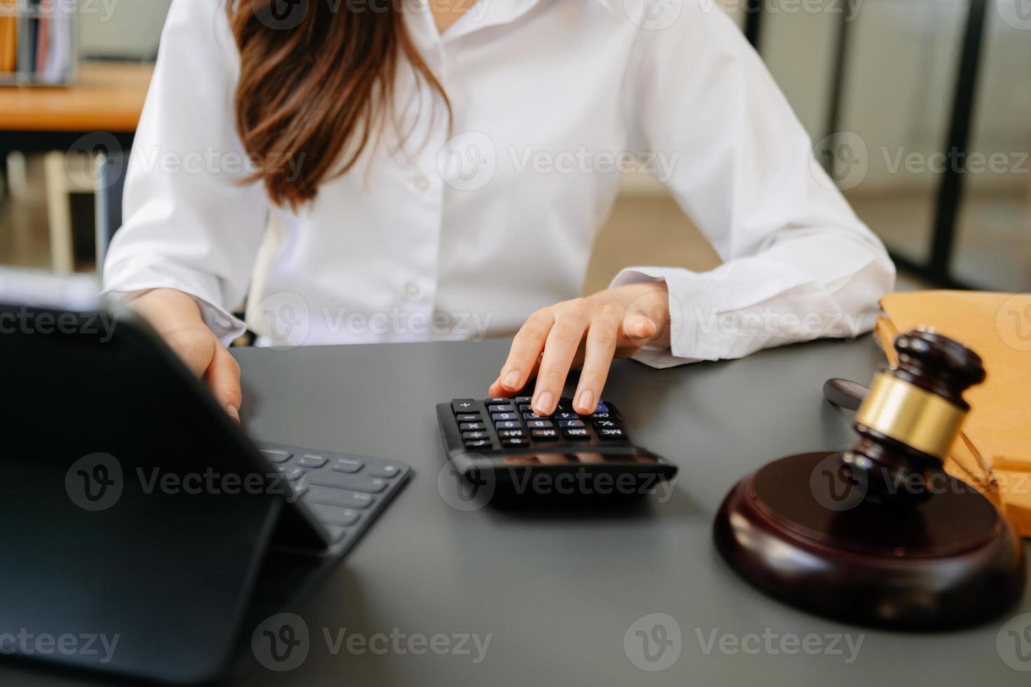 justice and law concept.businessman or lawyer or accountant working on accounts using a smart phone laptop digital tablet  calculator  and documents in dark photo