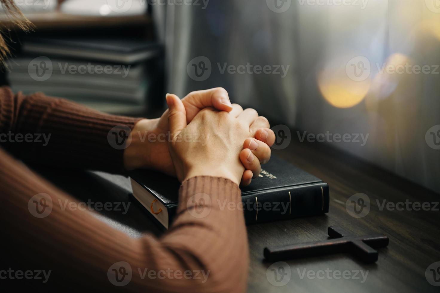 Hands together in prayer to God along with the bible In the Christian concept and religion, woman pray in the Bible photo