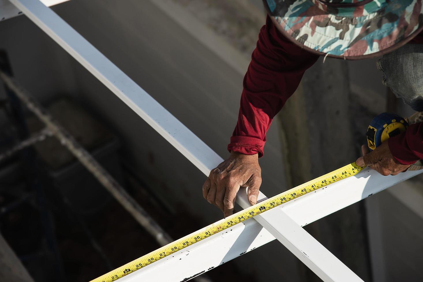 en el sitio construcción trabajador con acero techo estructura instalación, residencial edificio contratista trabajo foto