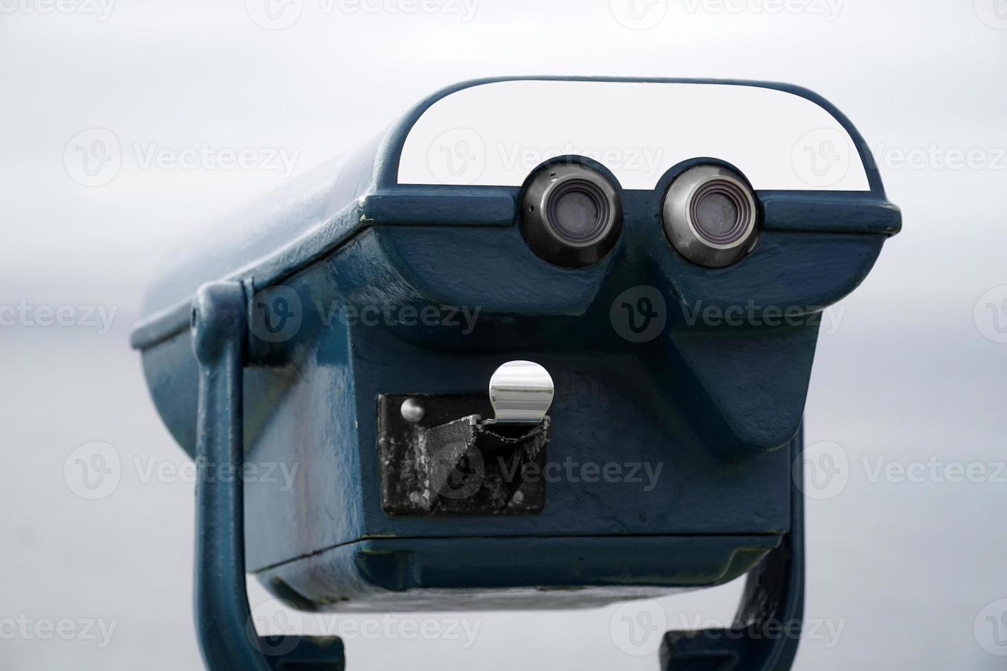 Blue Tourist Binoculars on Coins and Defocused Sea on Second Plan photo