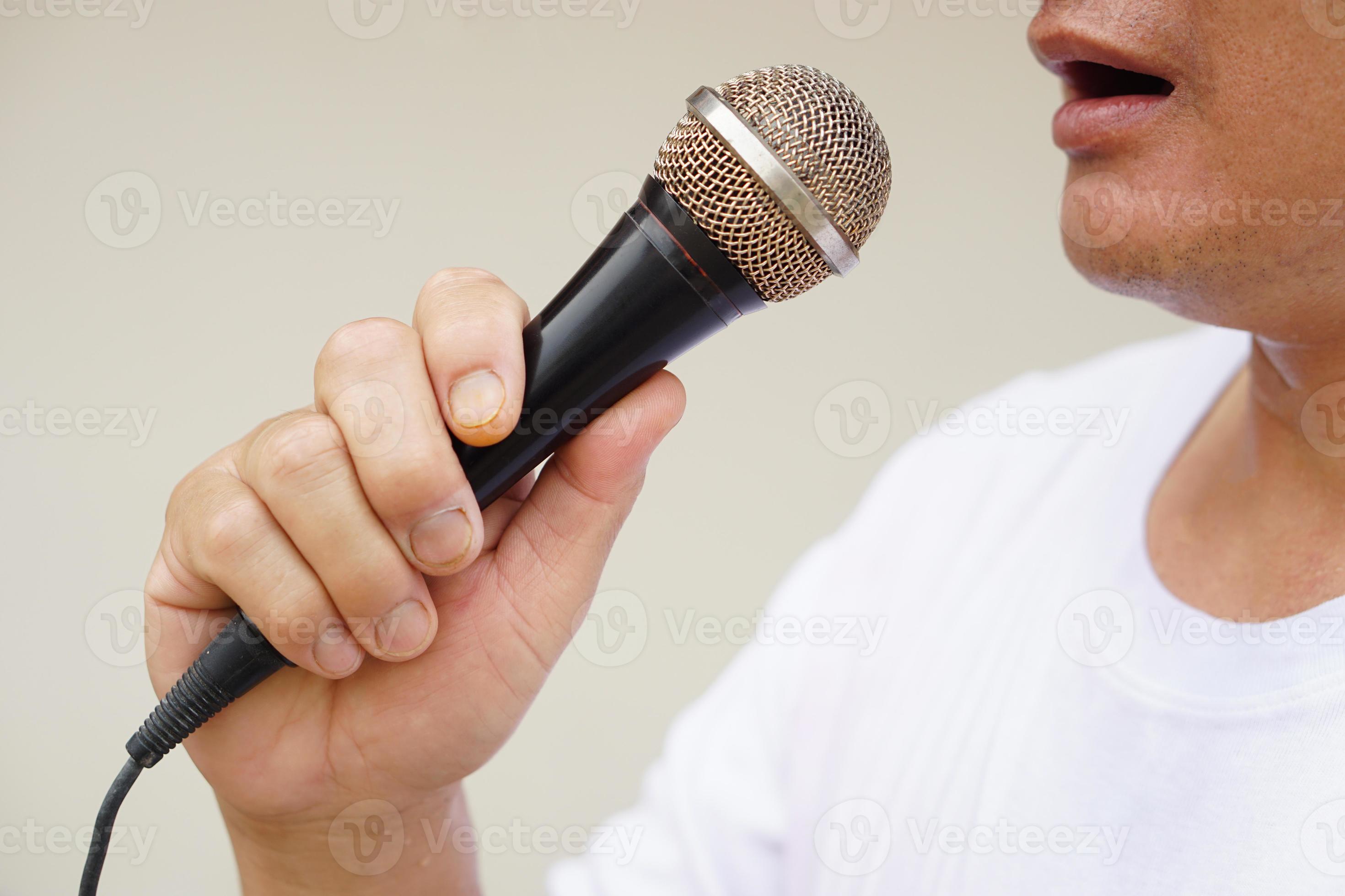 Man holds and speak or sing on microphone. Concept, tool or device 