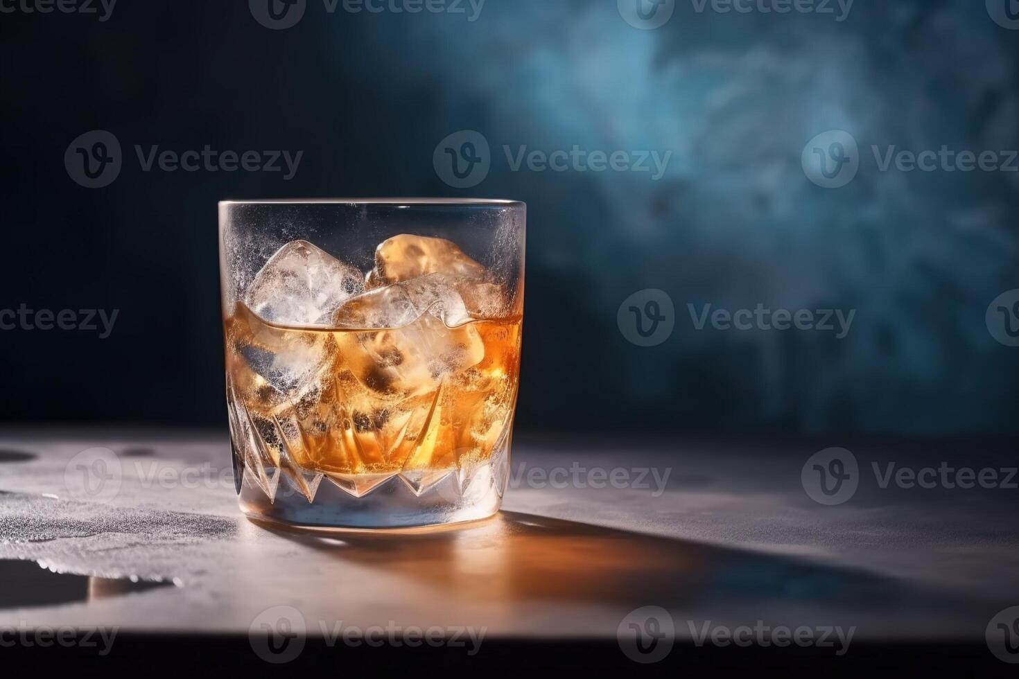 Old fashioned glass of whiskey with ice, lighted from back. . photo