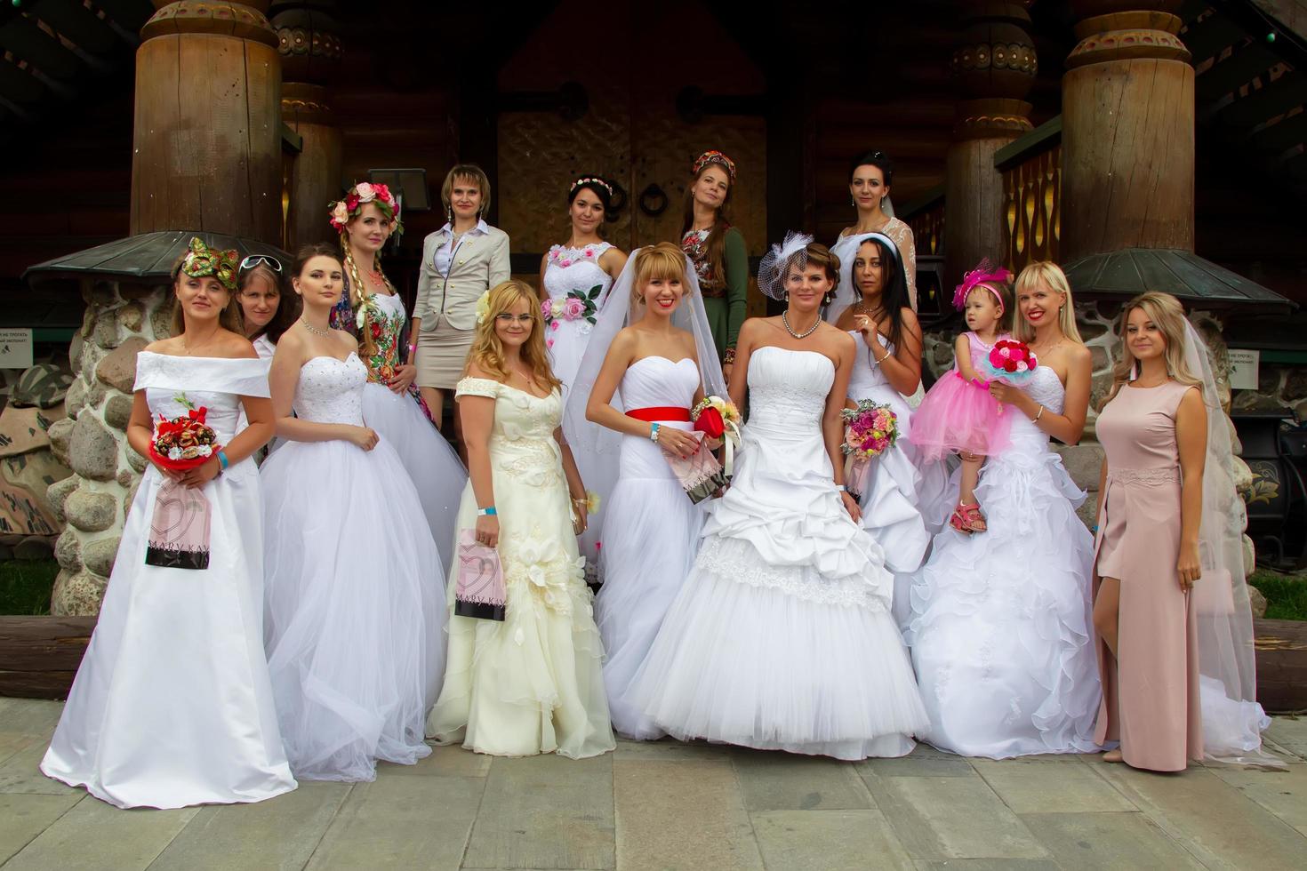 The parade of brides. A lot of women in wedding dresses. A group of brides. photo