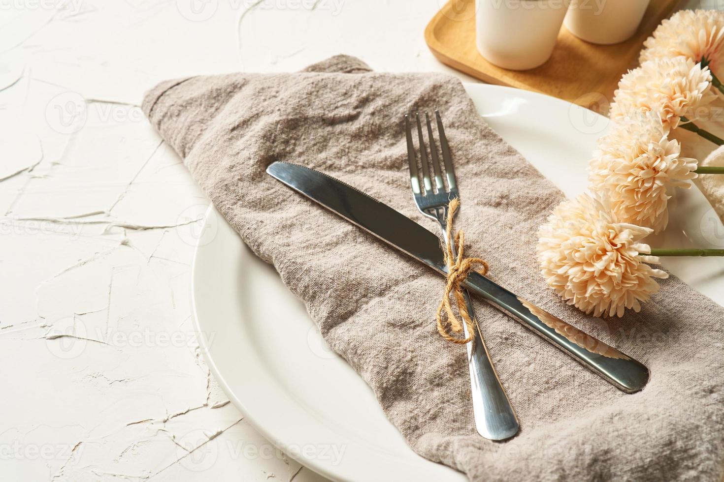 food concept stylish table setting cutlery on white table with silver fork and knife photo