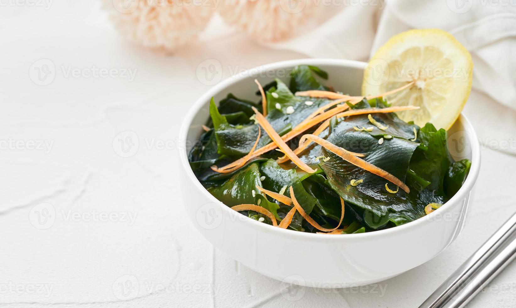 close up salad laminaria Kelp or wakame seaweed salad in bowl on white table background with copy space. salad laminaria Kelp or wakame seaweed salad food photo